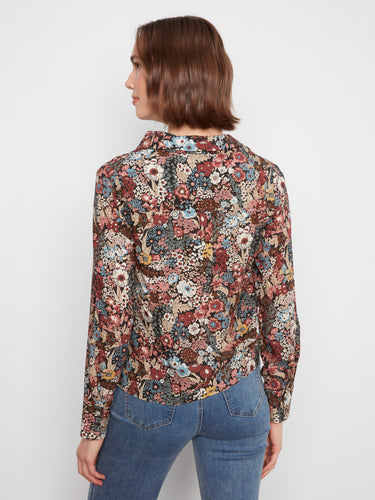 Elegant floral blouse highlighting the twisted front detail and vibrant patterns by Charlie B.