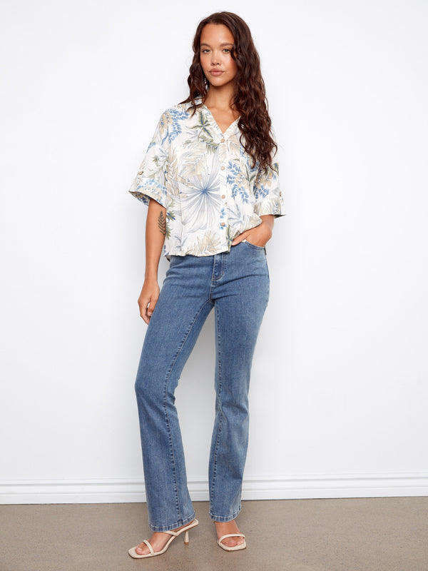 Button-front floral blouse showcasing a Hawaiian print and stylish shirt collar, perfect for casual outings by Charlie B.