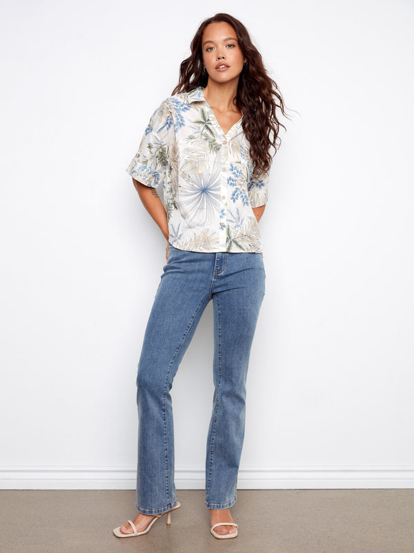 Chic Hawaiian print blouse featuring short sleeves with button tabs and a comfortable fit for everyday wear by Charlie B.