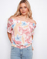 Floral top with an off-the-shoulder design and short flutter sleeves, offering a breezy summer look by Charlie B.