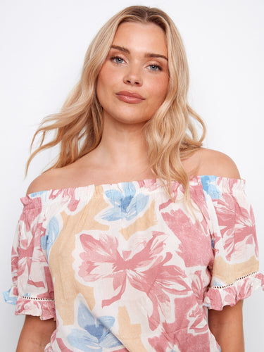 Chic floral blouse featuring short flutter sleeves that add a playful touch to your outfit by Charlie B.