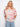 Vibrant floral pattern enhances this off-the-shoulder blouse, perfect for casual outings by Charlie B.