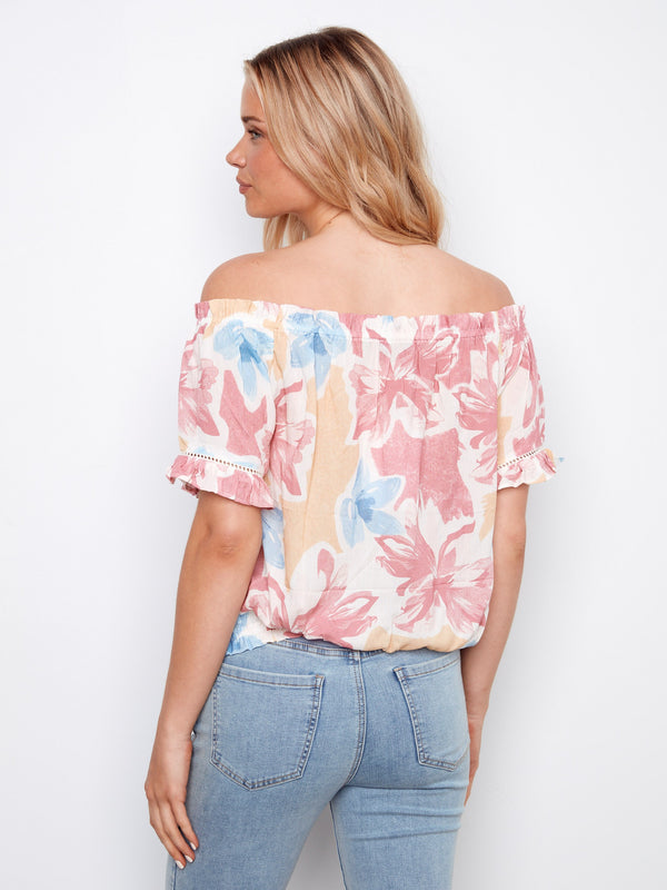 Romantic short flutter sleeves on this floral top provide an elegant yet relaxed style by Charlie B.