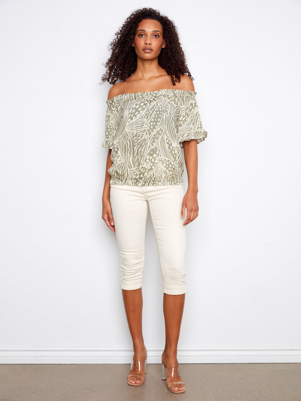 Stylish off-the-shoulder blouse with an elastic hem, offering a comfortable and flattering fit. Ideal for any casual occasion by Charlie B.