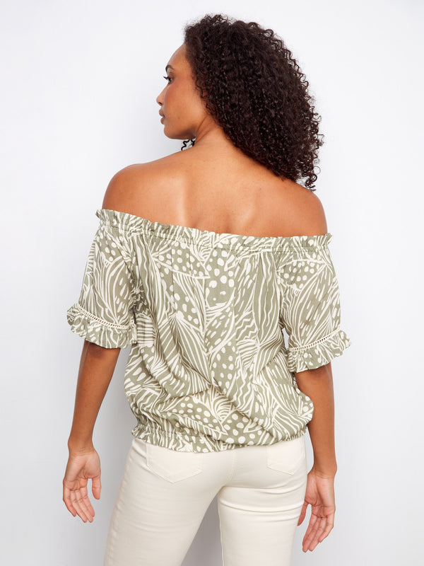 Charming top showcasing short flutter sleeves and an eye-catching design. The elastic hem provides ease of movement by Charlie B.