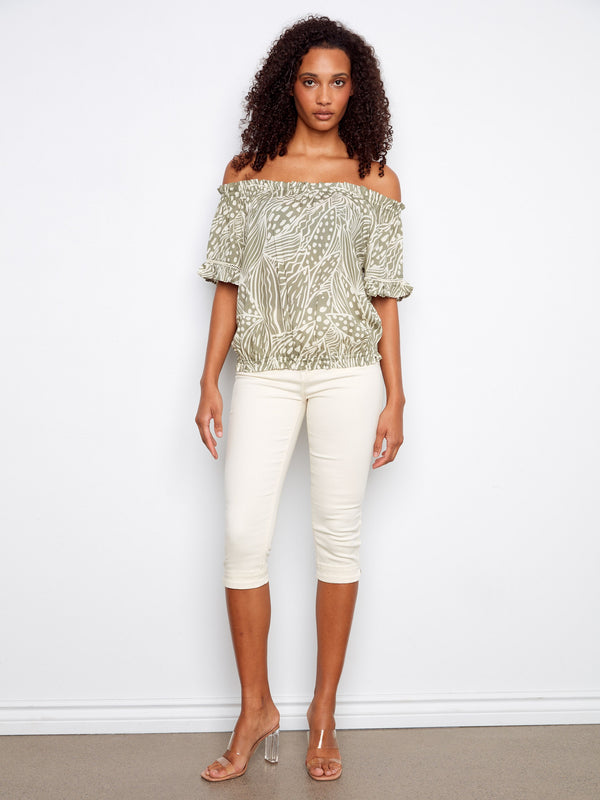 Trendy off-the-shoulder shirt with unique detailing, featuring a relaxed fit through its elastic hem and flutter sleeves by Charlie B.