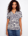 Patterned blouse featuring a V neckline, crafted from a soft linen blend for comfort and style. By Charlie B.