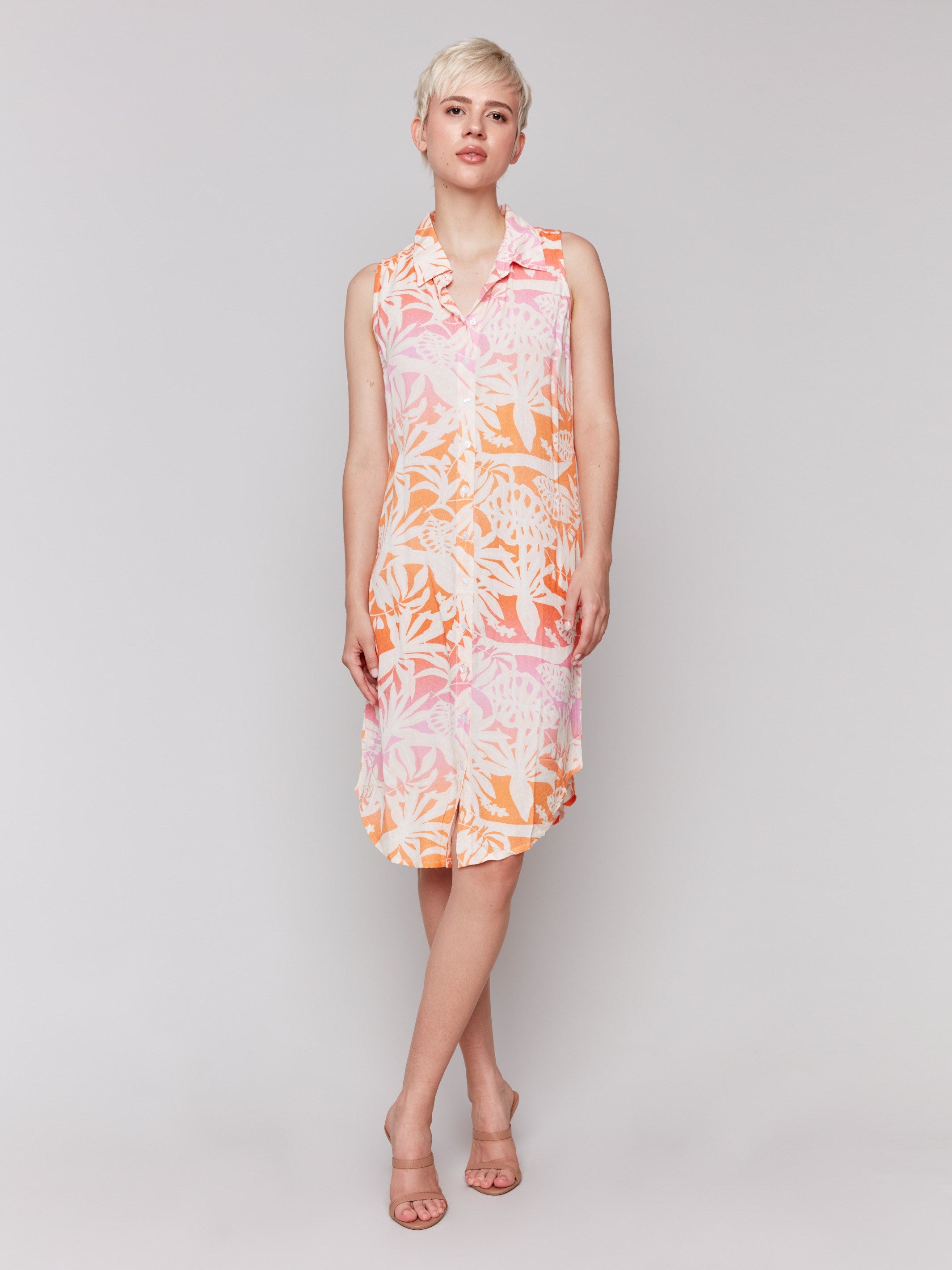Button-front sleeveless dress featuring a rounded hemline by Charlie B.