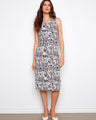 Elegant dress featuring a scoop neckline, showcasing intricate patterns and a comfortable fit. Designed by Charlie B.