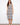 Elegant dress featuring a scoop neckline, showcasing intricate patterns and a comfortable fit. Designed by Charlie B.