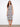 Elegant dress featuring a scoop neckline, showcasing intricate patterns and a comfortable fit. Designed by Charlie B.
