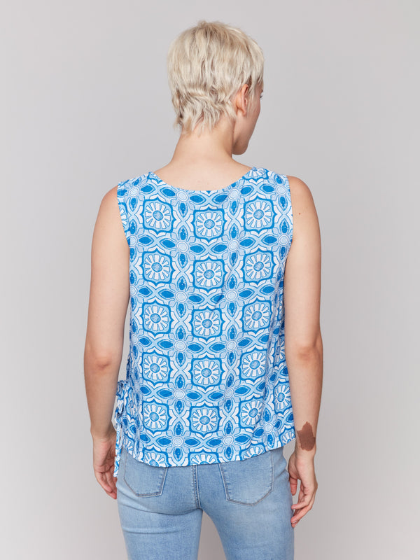 Artistic illusion print on a sleeveless top, ideal for warm weather fashion by Charlie B.