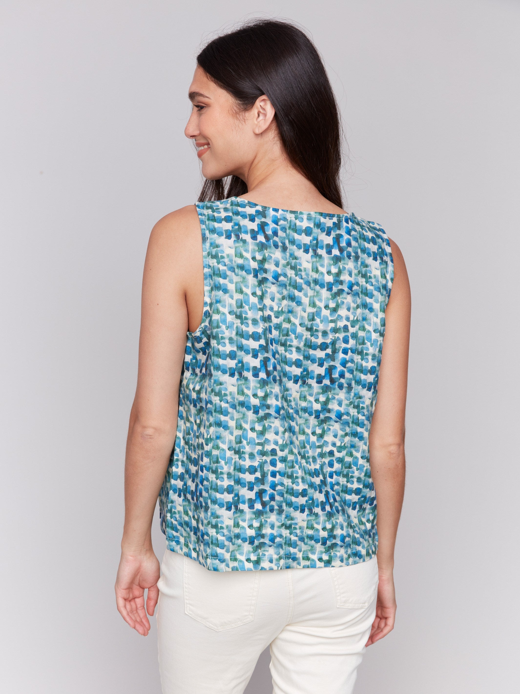 Stylish lilypad sleeveless design with hem slit by Charlie B.