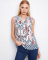 Abstract floral print top with ruffle neckline, offering a sleeveless design by Charlie B.
