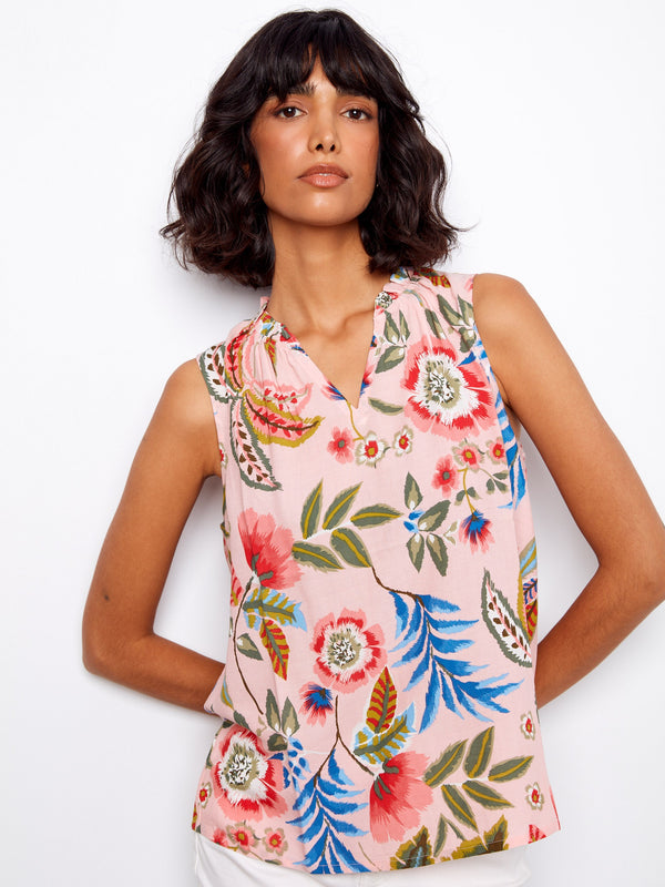The vibrant floral pattern on this V-neck top brightens up any outfit effortlessly by Charlie B.