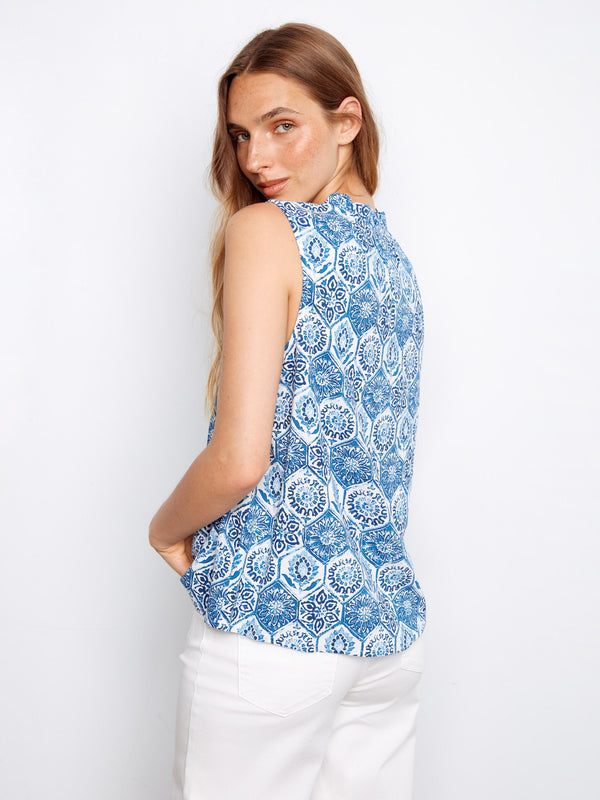 The intricate ruffled neckline detail enhances the elegance of this blue patterned top, brought to you by Charlie B.