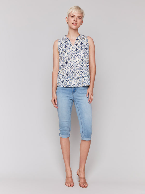 Elegant sleeveless blouse with unique design elements by Charlie B.