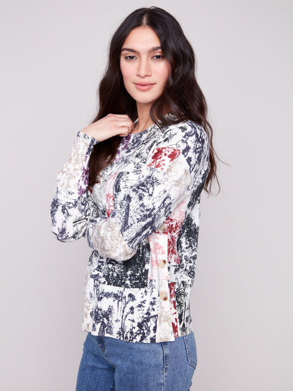 Long-sleeve sweater showcasing intricate side buttons and vibrant abstract Frame design by Charlie B.