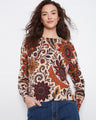 This sweater features a crew neck with intricate floral patterns, adding a touch of elegance and style to any outfit by Charlie B.