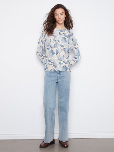 Elegant floral top with a drop shoulder design, offering comfort and style in one piece. By Charlie B.