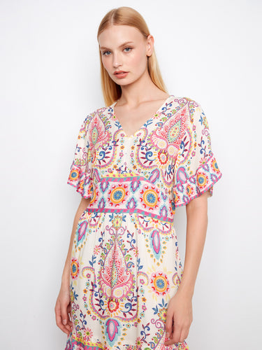 Elegant dress adorned with vibrant patterns, highlighted by its flutter sleeves and artistic flair by Charlie B.
