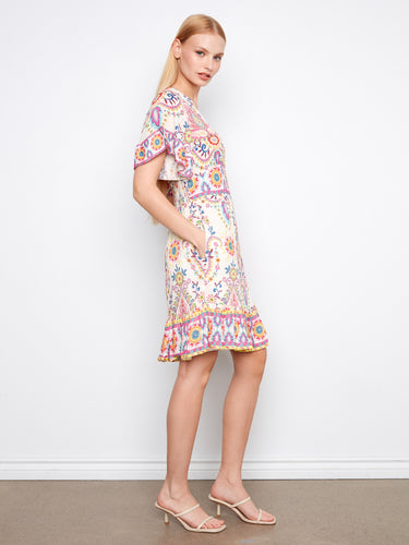 Chic floral dress showcasing a smocked waistband for a tailored fit, complemented by vivid abstract motifs by Charlie B.