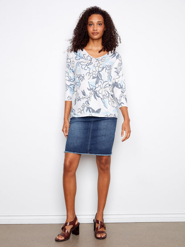 Chic and stylish V-neck top adorned with a unique placement print design, ideal for your wardrobe. Crafted by Charlie B.