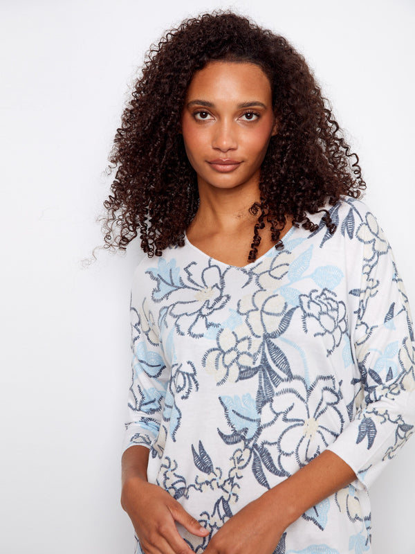 This fashionable top showcases a beautiful placement print design and comfortable 3/4 sleeves, designed by Charlie B.