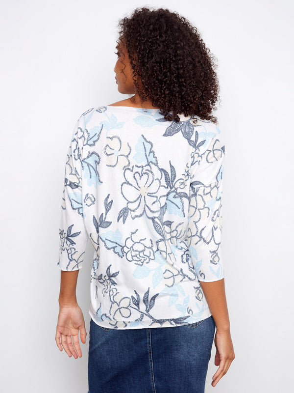 Stylish V-neck top featuring an eye-catching placement print and versatile 3/4 sleeves, exclusively from Charlie B.