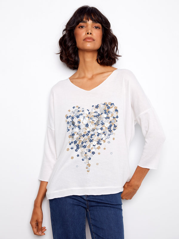 White V-neck top with a charming placement print design and 3/4 sleeves, perfect for casual outings by Charlie B.