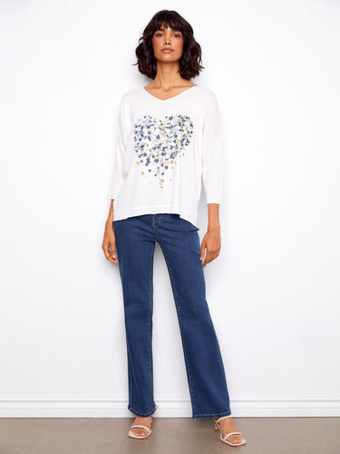 Stylish white top with 3/4 sleeves and intricate floral print in blue and beige hues by Charlie B.