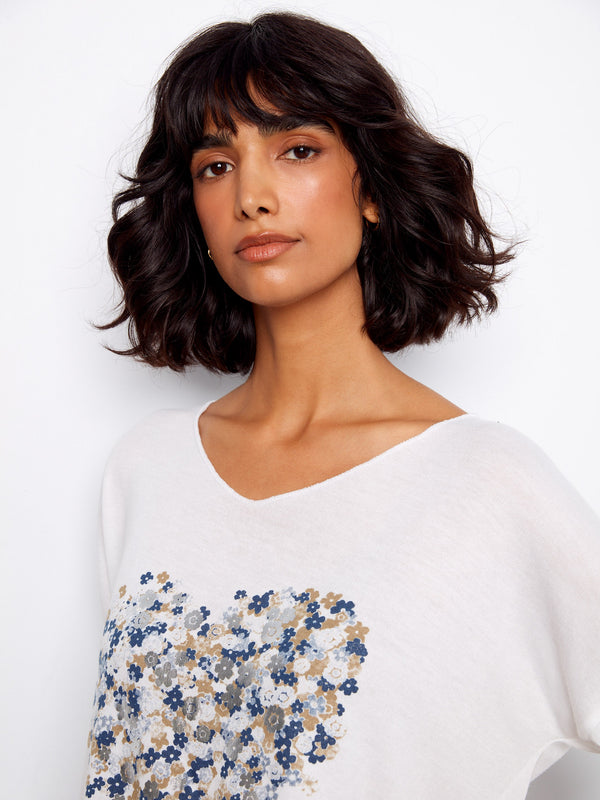 Chic white top showcasing a unique heart-shaped floral pattern with 3/4 sleeves for added style by Charlie B.