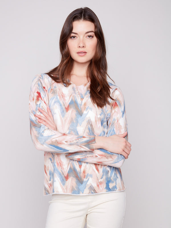 Long sleeves enhance the sweater's colorful chevron pattern and plushy yarn texture, adding style by Charlie B.