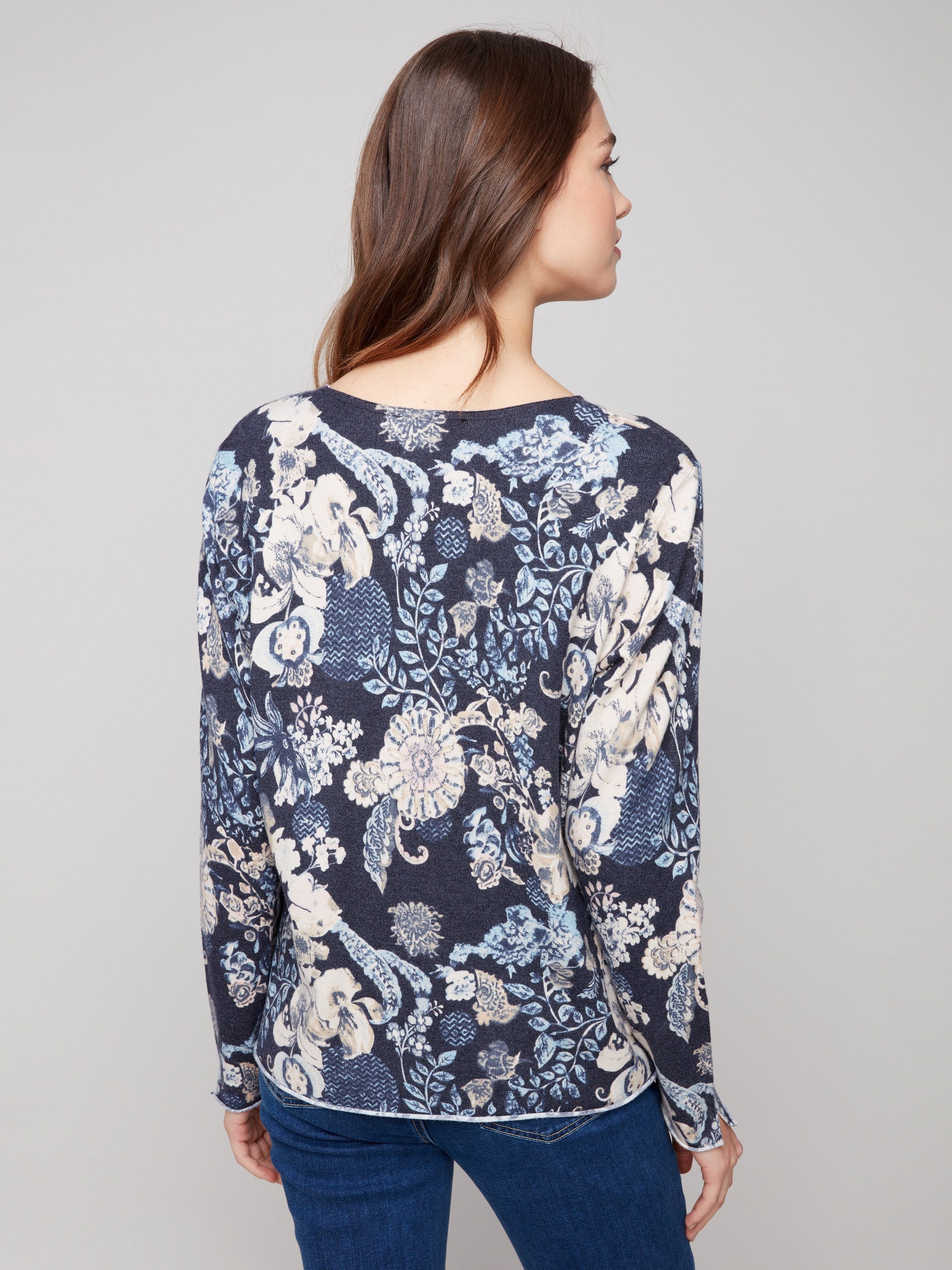 Sweater with a plushy yarn texture and colorful floral pattern, detailed with side slits at cuffs and hem by Charlie B.