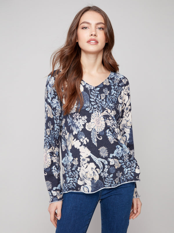 Sweater featuring vibrant florals on a soft yarn texture, perfect for any casual occasion by Charlie B.