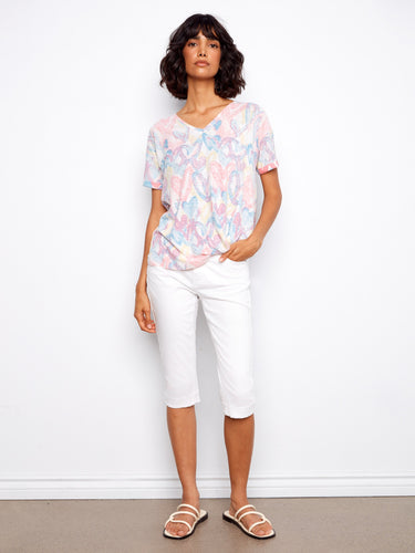 Chic short-sleeved T-shirt with a colorful heart pattern and playful side knot accent by Charlie B.