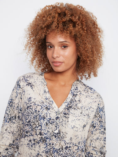 Elegant floral print blouse offering both style and practicality in one chic package. By Charlie B.