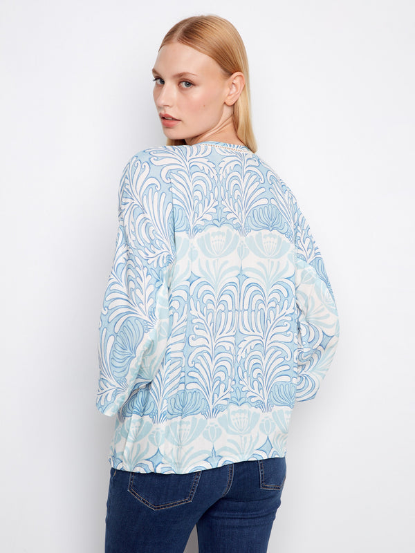 Adorned with intricate ladder stitch detail, this top adds a touch of elegance to your wardrobe by Charlie B.