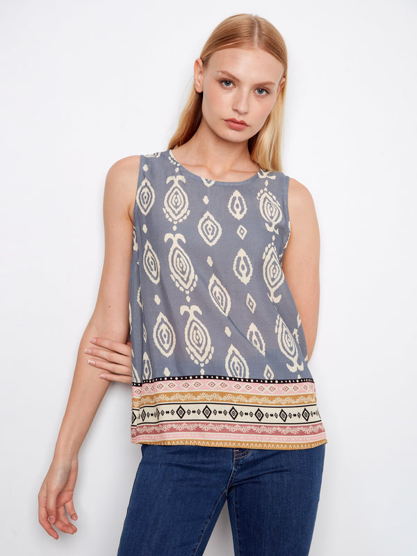 Blue sleeveless top with a striking pattern and crew neckline, accented by a detailed border design for added flair by Charlie B.