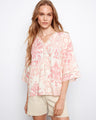 Blouse with wide elbow sleeves and abstract pink and white pattern, featuring a relaxed fit by Charlie B.