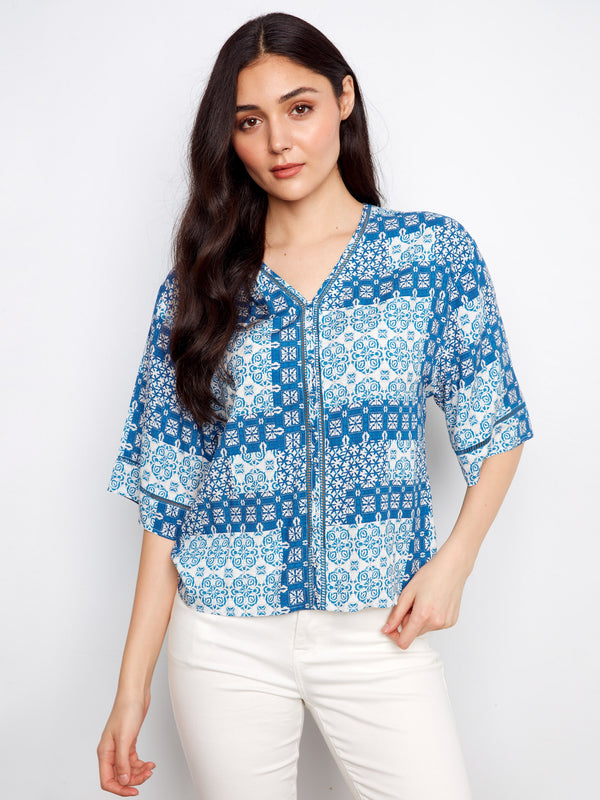 This top features a stylish V-neckline that adds a touch of elegance to any look. Perfect for casual outings or dressy occasions by Charlie B.