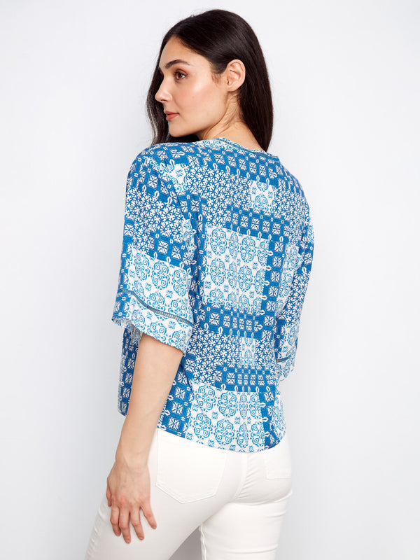 The button-front detail enhances the design of this top, adding functionality and flair to your wardrobe essentials by Charlie B.