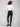 Chic black slim-leg pants with stretch fabric paired elegantly with a white top by Charlie B.