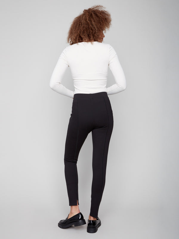 Chic black slim-leg pants with stretch fabric paired elegantly with a white top by Charlie B.