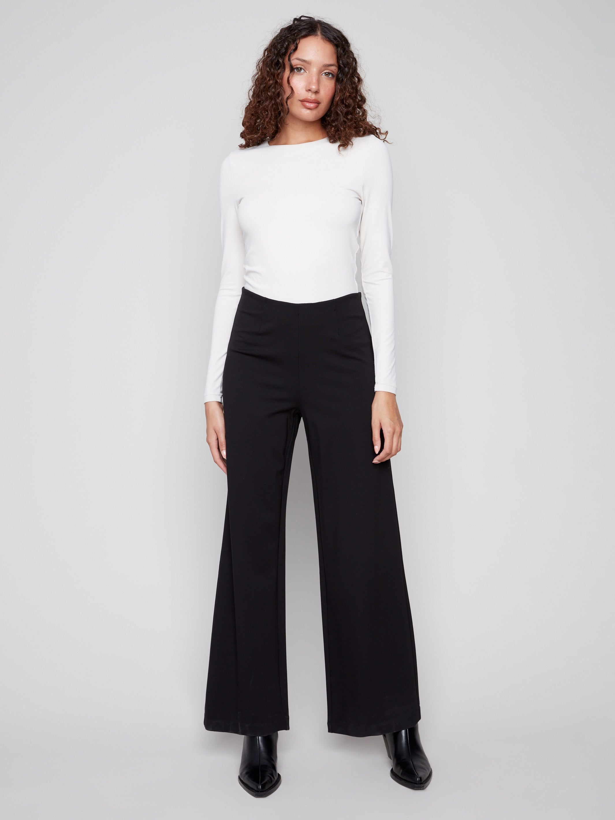 Black pants with a flattering wide-leg silhouette, offering both comfort and style for versatile wear, by Charlie B.