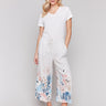 Linen blend pants with a wide leg fit and colorful floral print by Charlie B.