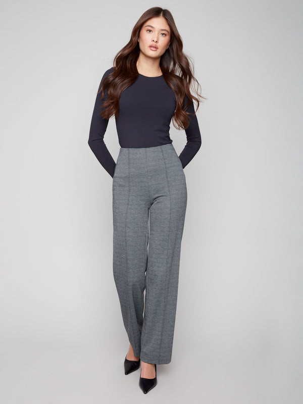 Black pull-on pants featuring a stylish wide-leg design and front dart detailing by Charlie B.