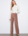 Taupe wide-leg corduroy pants in full length, styled with a white ribbed sweater for a chic look by Charlie B.