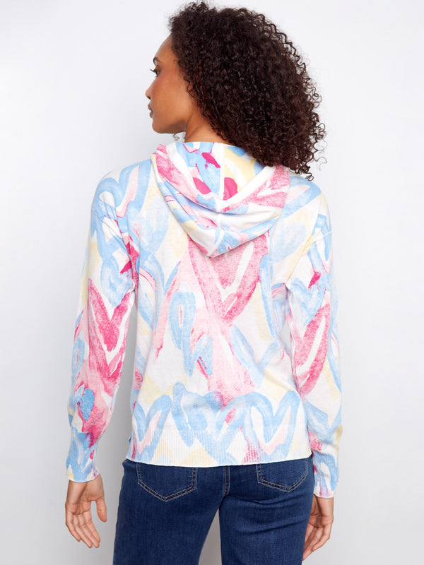 This cozy hoodie showcases a lively blend of colors and patterns, ideal for adding fun to any outfit. Made uniquely by Charlie B.