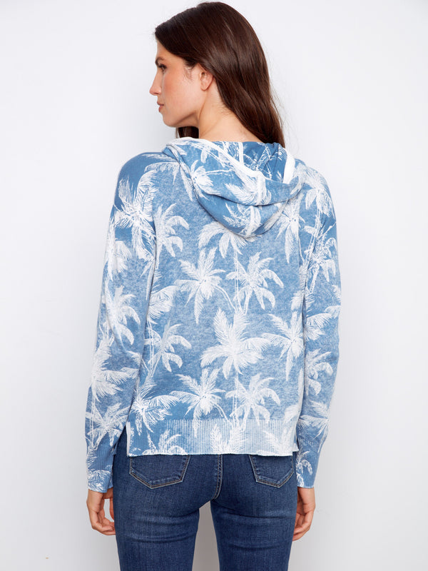 Elevate your wardrobe with this chic blue hoodie made of soft 100% cotton, adorned with a distinctive reverse print design. Effortlessly cool. by Charlie B.